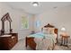 Bright bedroom featuring a wooden bed frame, dresser with mirror, and stylish decor at 1209 Shelly Woods Dr, Indian Land, SC 29707