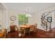 Cozy dining room with hardwood floors, classic wainscoting, and stairway access at 1209 Shelly Woods Dr, Indian Land, SC 29707