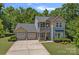 Charming two-story home with a spacious three-car garage and beautifully landscaped front yard at 1209 Shelly Woods Dr, Indian Land, SC 29707