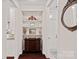 Hallway with dark wood floors, built-in shelving with decorative items, and white trim at 1209 Shelly Woods Dr, Indian Land, SC 29707