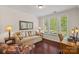 Comfortable home office with hardwood floors, a bright window, and a cozy sofa at 1209 Shelly Woods Dr, Indian Land, SC 29707