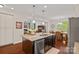 Kitchen island with granite countertops and stainless steel appliances, open to living and dining areas at 1209 Shelly Woods Dr, Indian Land, SC 29707