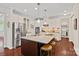 Bright kitchen features stainless appliances, granite counters, central island, and hardwood floors at 1209 Shelly Woods Dr, Indian Land, SC 29707