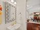 Stylish powder room featuring a decorative mirror, modern fixtures, and an elegant sink at 1209 Shelly Woods Dr, Indian Land, SC 29707