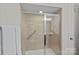 Tiled shower with a glass door, grab bar, and recessed lighting at 1209 Shelly Woods Dr, Indian Land, SC 29707