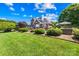 Lush backyard featuring manicured landscaping, a patio area, and mature trees, creating a private outdoor oasis at 132 Broadbill Dr, Mooresville, NC 28117