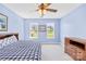 A tidy bedroom features neutral-toned walls, two windows, and a traditional bed at 132 Broadbill Dr, Mooresville, NC 28117