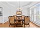 Elegant dining room with a wood table set, chandelier, and natural light from shuttered windows at 132 Broadbill Dr, Mooresville, NC 28117
