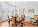 Dining room with wood table, chandelier, and many windows providing natural light at 132 Broadbill Dr, Mooresville, NC 28117