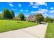 Beautiful two-story brick home with a well-manicured lawn and mature trees, offering a picturesque curb appeal at 132 Broadbill Dr, Mooresville, NC 28117