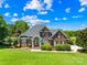 Stately brick home with manicured landscaping, featuring a covered entrance and a grand, welcoming facade at 132 Broadbill Dr, Mooresville, NC 28117
