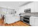 Well-lit kitchen featuring white cabinetry, stainless steel appliances, marble countertops, and sleek modern design at 132 Broadbill Dr, Mooresville, NC 28117