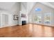 Spacious living room featuring a fireplace, hardwood floors, and multiple windows for natural light at 132 Broadbill Dr, Mooresville, NC 28117