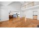 Open-concept living room with hardwood floors, connecting to a dining area and kitchen, and a loft area at 132 Broadbill Dr, Mooresville, NC 28117