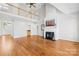 Bright living room with hardwood floors, a loft area, and a fireplace creates a welcoming space at 132 Broadbill Dr, Mooresville, NC 28117