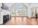 Bright living room with fireplace, large windows, and hardwood floors; ideal for gatherings at 132 Broadbill Dr, Mooresville, NC 28117