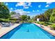 Inviting backyard pool with chairs, umbrella-covered table, and lush landscaping ideal for relaxation and entertainment at 132 Broadbill Dr, Mooresville, NC 28117