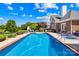 Sparkling backyard pool surrounded by patio, lush lawn, and comfortable lounge chairs for relaxation and enjoyment at 132 Broadbill Dr, Mooresville, NC 28117