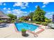 Inviting backyard pool with chairs, sun, and plenty of trees at 132 Broadbill Dr, Mooresville, NC 28117