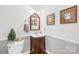 Stylish powder room with a charming vanity, decorative mirror, and elegant fixtures, adding a touch of sophistication at 132 Broadbill Dr, Mooresville, NC 28117