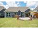 Large, grassy backyard features a patio with stylish seating, a pergola, and a well-manicured lawn at 13339 Mcguffy Dr, Huntersville, NC 28078