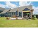 Spacious backyard features a patio with seating, a lush lawn, and a charming pergola at 13339 Mcguffy Dr, Huntersville, NC 28078