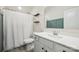 Well-lit bathroom features a white vanity, toilet, shower with curtain, and two modern floating shelves at 13339 Mcguffy Dr, Huntersville, NC 28078
