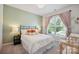 Bright bedroom featuring a large window, neutral carpeting, and soft-green walls at 13339 Mcguffy Dr, Huntersville, NC 28078