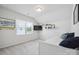 Bright bedroom with neutral walls, large window, wall-mounted shelves, and a white bed at 13339 Mcguffy Dr, Huntersville, NC 28078