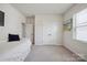 Inviting bedroom featuring a bed with drawers, a large window, and a double-door closet at 13339 Mcguffy Dr, Huntersville, NC 28078