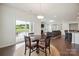 Sunlit dining area with wood floors and sliding glass doors leading to the patio at 13339 Mcguffy Dr, Huntersville, NC 28078