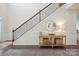 Elegant entryway featuring a staircase with dark railings, console table, and a rug at 13339 Mcguffy Dr, Huntersville, NC 28078