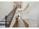 Bright and airy foyer showcasing a grand staircase, hardwood floors, and elegant décor at 13339 Mcguffy Dr, Huntersville, NC 28078