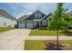 Charming single-story home boasts a manicured lawn, attached two-car garage, and welcoming front porch at 13339 Mcguffy Dr, Huntersville, NC 28078