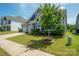 A well-kept single-story home with manicured landscaping, a spacious lawn, and an attached garage at 13339 Mcguffy Dr, Huntersville, NC 28078