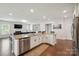 Kitchen with granite countertops, stainless steel appliances, and open-concept design connecting to the living room at 13339 Mcguffy Dr, Huntersville, NC 28078