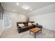 Spacious living room with a comfortable brown leather sectional and a coffee table at 13339 Mcguffy Dr, Huntersville, NC 28078