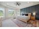 A serene main bedroom features a tray ceiling, a decorative wall, and large windows at 13339 Mcguffy Dr, Huntersville, NC 28078