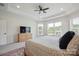 Bright main bedroom with three large windows, tray ceiling and neutral carpeting at 13339 Mcguffy Dr, Huntersville, NC 28078