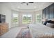 Spacious main bedroom featuring three windows, a tray ceiling, and plush carpet at 13339 Mcguffy Dr, Huntersville, NC 28078