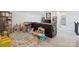 Large playroom with a brown leather couch, television, and many toys at 13339 Mcguffy Dr, Huntersville, NC 28078