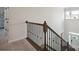 View of a staircase featuring wooden handrails and decorative black iron balusters at 13339 Mcguffy Dr, Huntersville, NC 28078