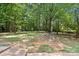 Expansive backyard featuring mature trees and a partially cleared area, creating a serene outdoor space at 1510 Sansberry Rd, Charlotte, NC 28262