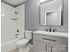Well-lit bathroom featuring a shower-tub combo, toilet, and modern vanity with sleek fixtures at 1510 Sansberry Rd, Charlotte, NC 28262