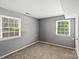 Neutral bedroom with carpet flooring, neutral paint, and natural light from two windows at 1510 Sansberry Rd, Charlotte, NC 28262