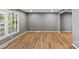 Bright living room with hardwood floors, large windows, and neutral paint at 1510 Sansberry Rd, Charlotte, NC 28262