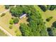 An aerial view shows a house nestled among lush green trees in a rural setting at 155 Mcallister Rd, Statesville, NC 28625