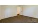 Cozy bedroom featuring carpet, white walls, closet, and neutral tones at 155 Mcallister Rd, Statesville, NC 28625