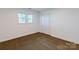 Bright bedroom features a window, neutral paint, plush carpeting, and a closet at 155 Mcallister Rd, Statesville, NC 28625