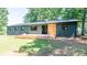 Backyard home view showcasing a metal roof and inviting wooden deck at 155 Mcallister Rd, Statesville, NC 28625